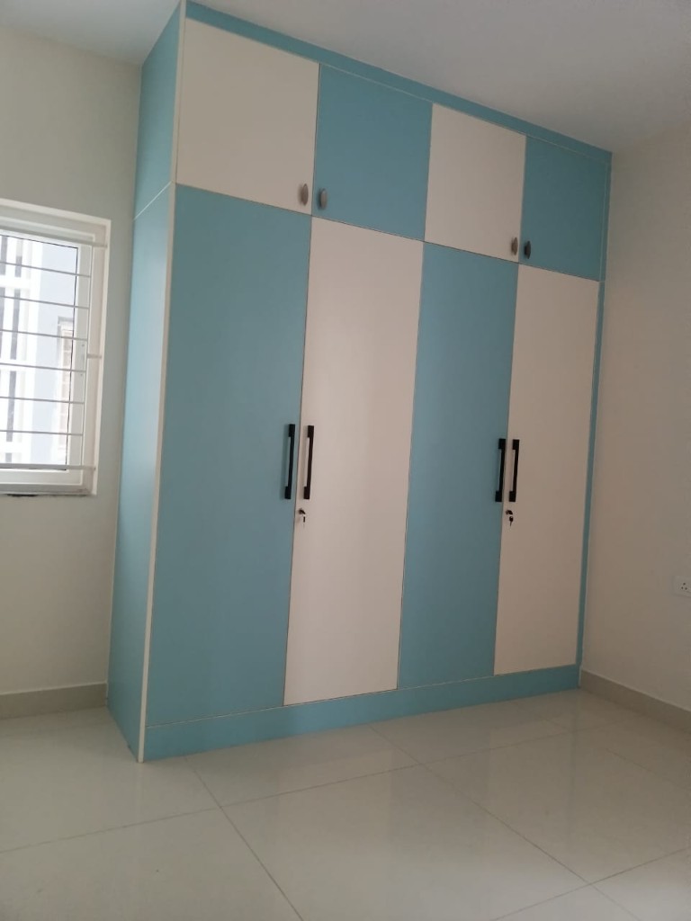 Marble-finish wardrobe with glass display and teal drawers